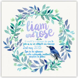 Watercolour wedding invitation design featuring leafy wreath and blue bird.